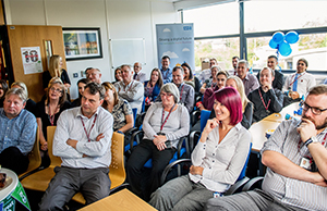 Photograph of colleagues listening to a presentation in celebration of the ten-year anniversary of NHS Informatics Merseyside